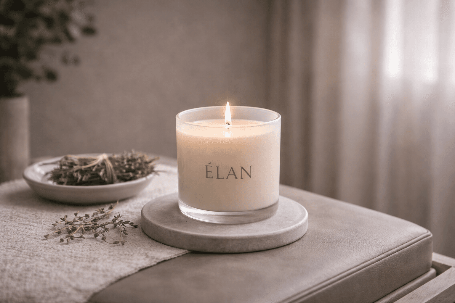 ELAN restorative candle lit on a stone coaster